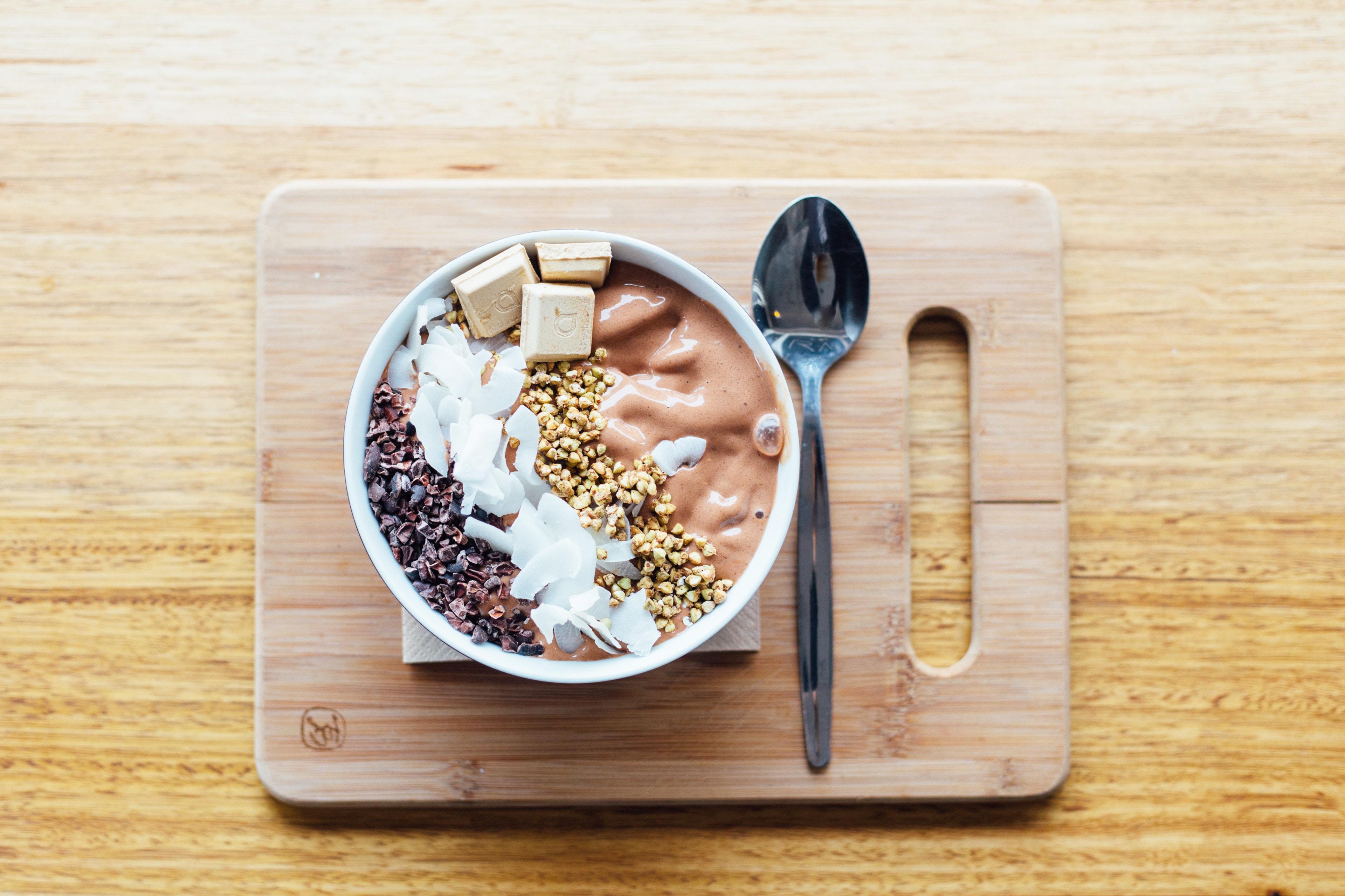 bowl of yogurt parfait on cutting board 