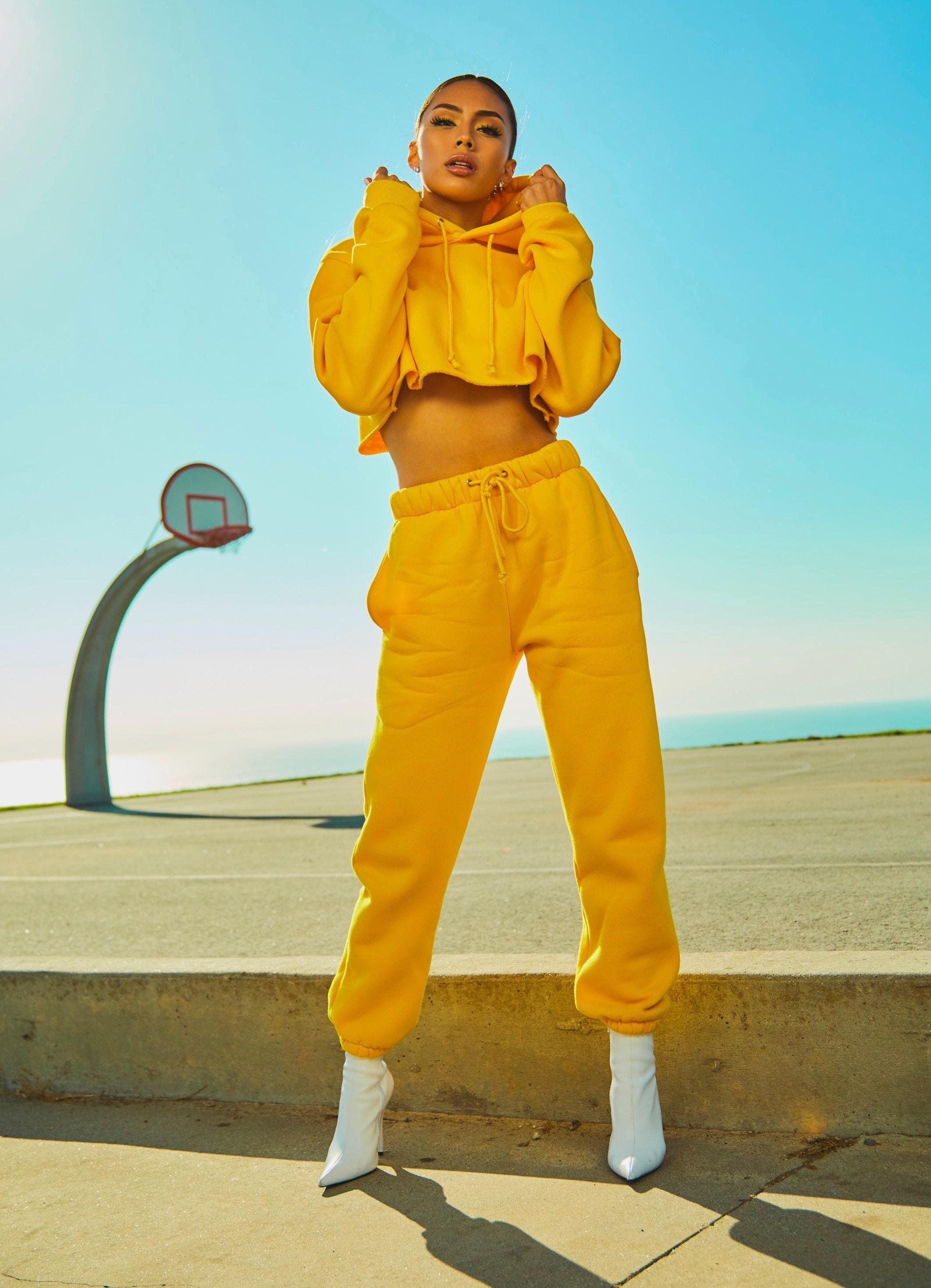 female model wearing yellow crop hoddie and sweatpants