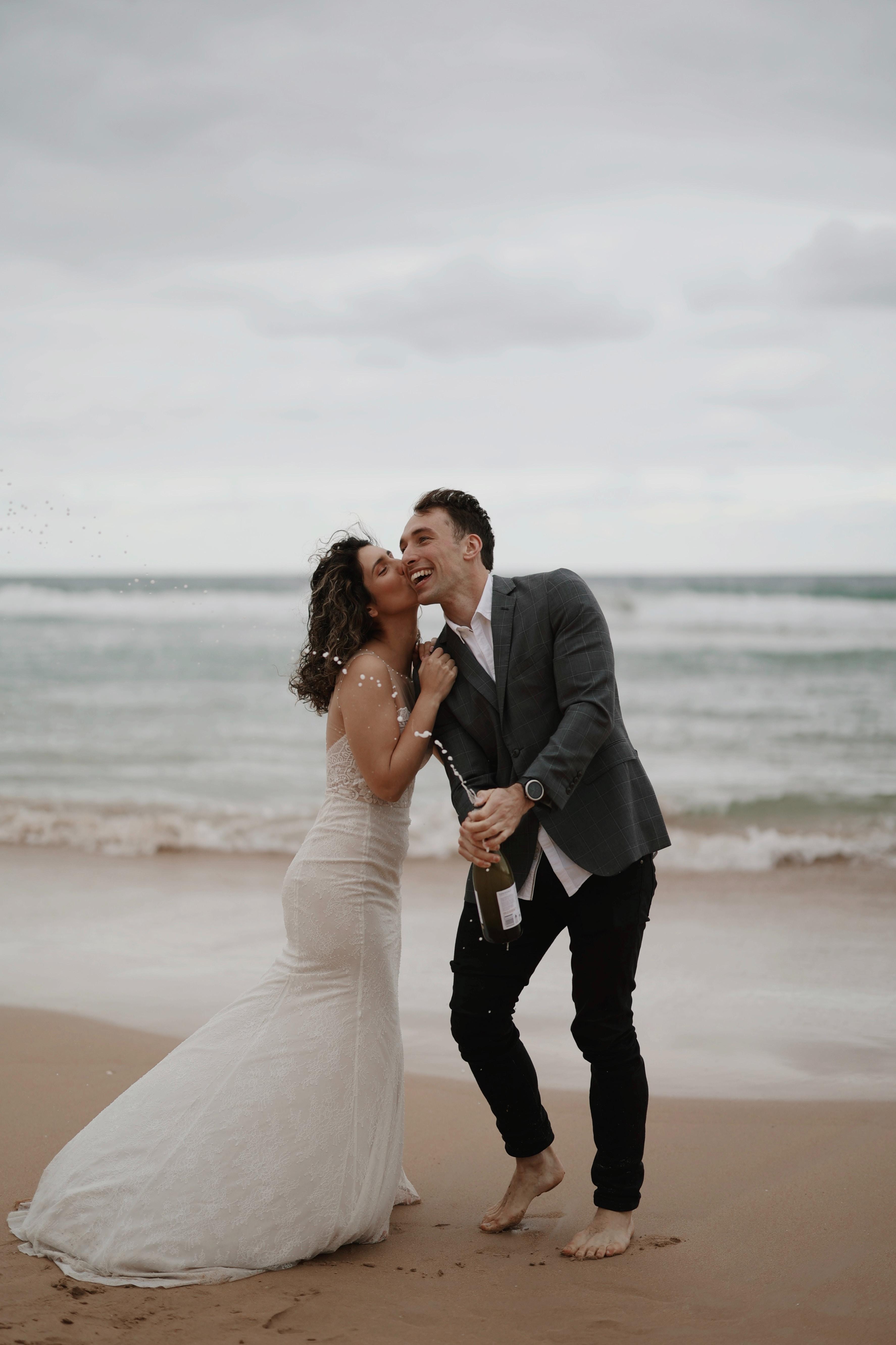 bride and groom on the beach, ocean in background