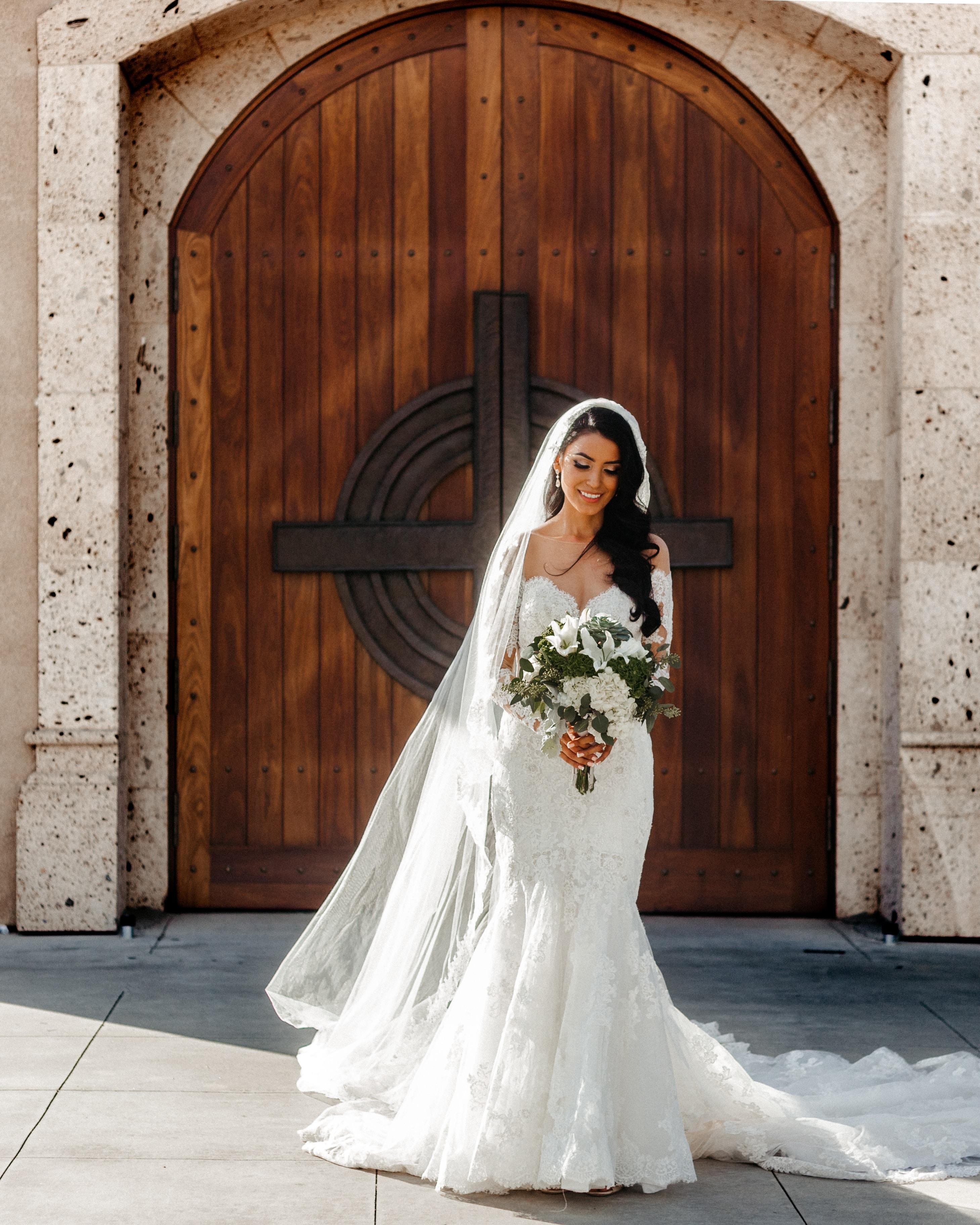 bride in front of wooden church door